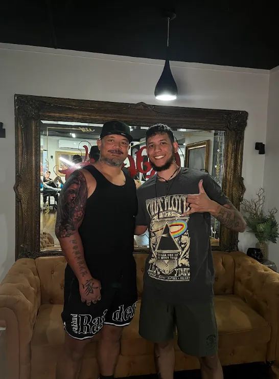 Julio Falcon with a client in the studio