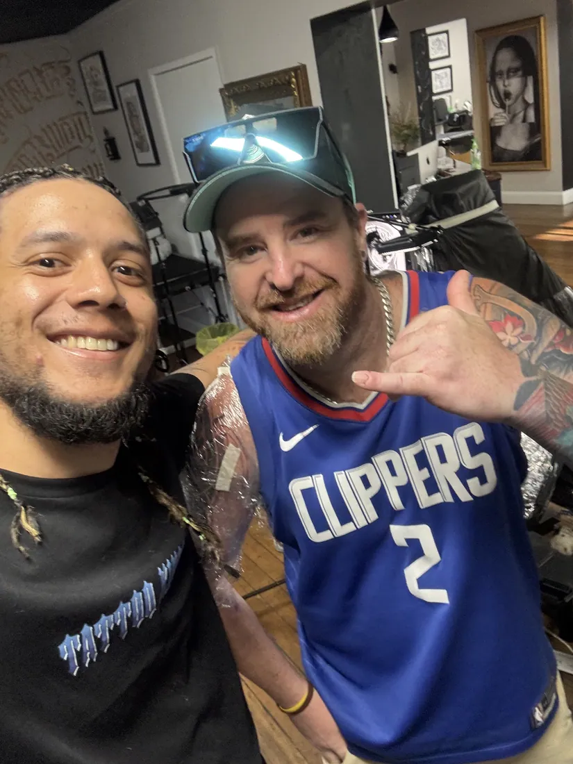 Julio Falcon with a client in the studio