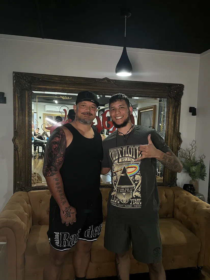 Julio Falcon with a client in the studio